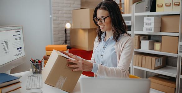 Person examining shipping boxes.